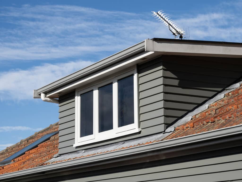 gray shed roof dormer loft with white window