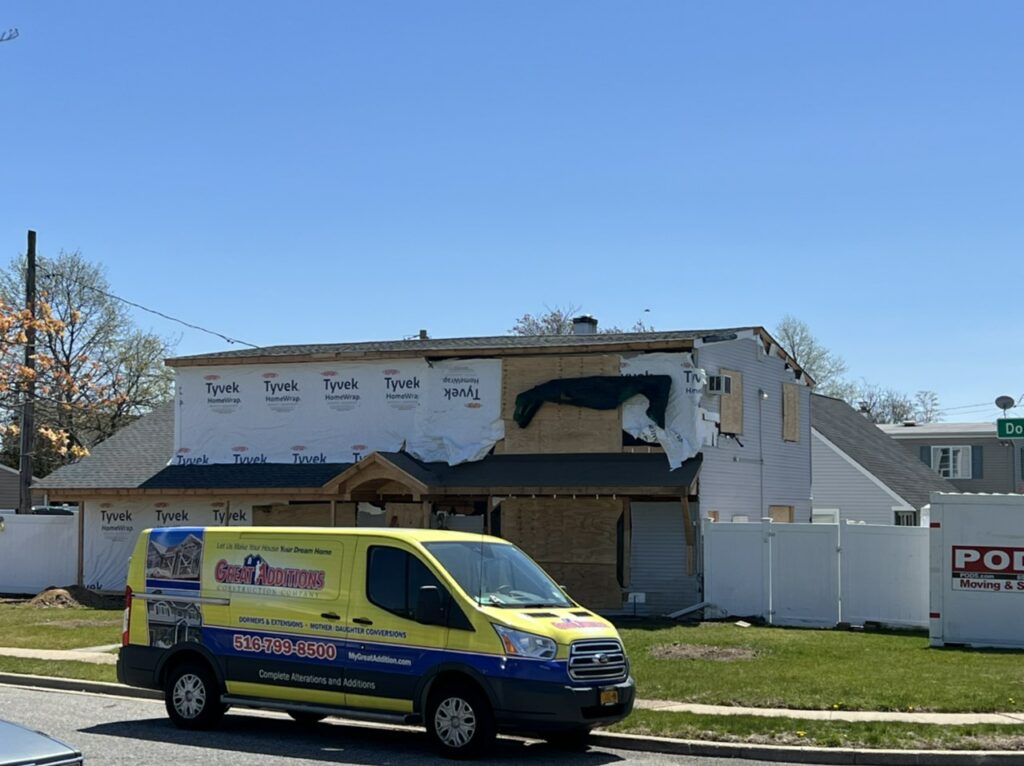 Great additions van outside a home remodel in progress