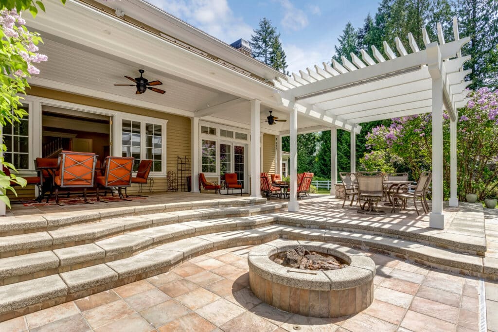 Outdoor patio with built in fire pit and pergola dining area